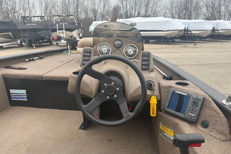 Slide: The Image of 2004 Express x17 boat dashboard with steering wheel and navigation equipment. - 9