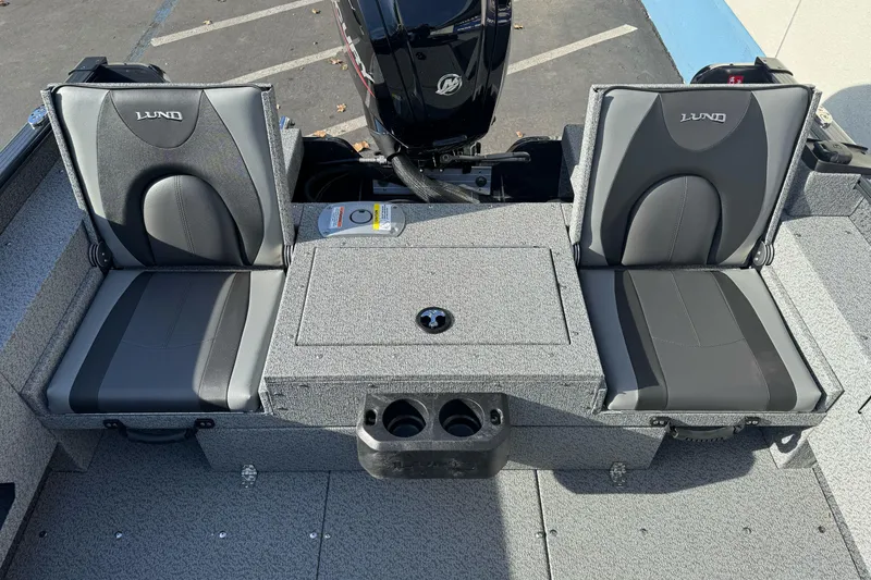 Slide: The Image of 2026 Lund 1675 Adventure SS boat interior with two gray seats and storage compartment. - 11