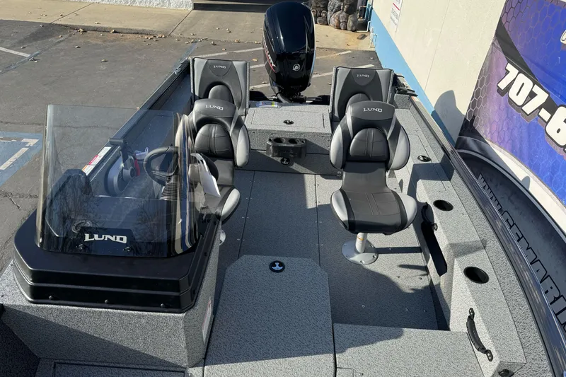 Slide: The Image of 2026 Lund 1675 Adventure SS boat interior with seating and steering console. - 14