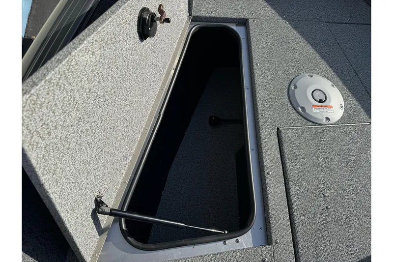 Slide: The Image of Open storage compartment on 2026 Lund 1675 Adventure SS boat deck. - 16