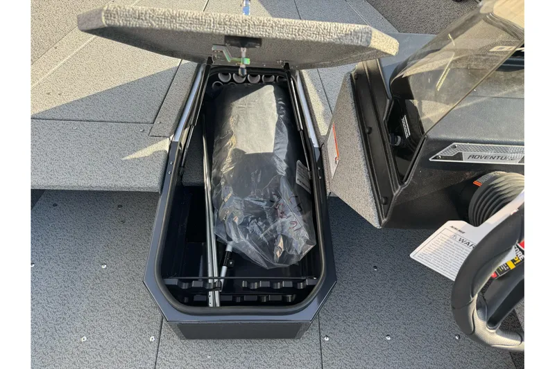 Slide: The Image of Open storage compartment in 2026 Lund 1675 Adventure SS boat, showcasing interior details. - 17