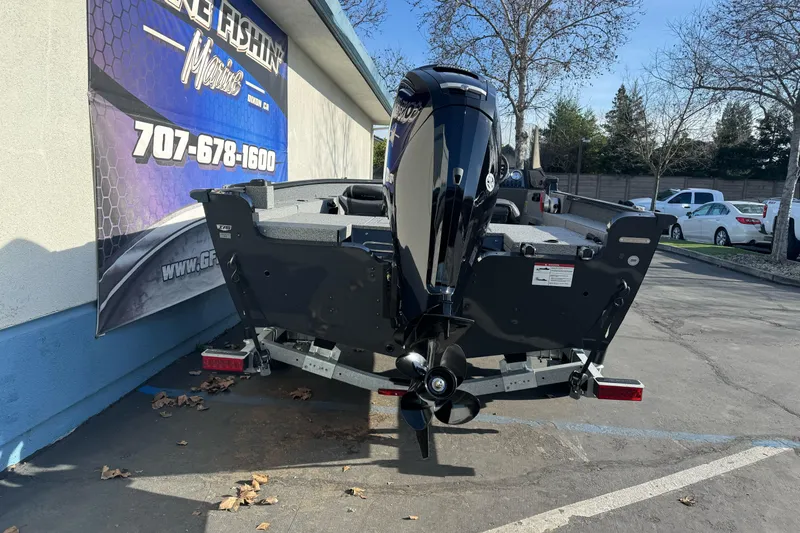 Slide: The Image of 2026 Lund 1675 Adventure SS boat on trailer, parked outdoors near a building. - 4