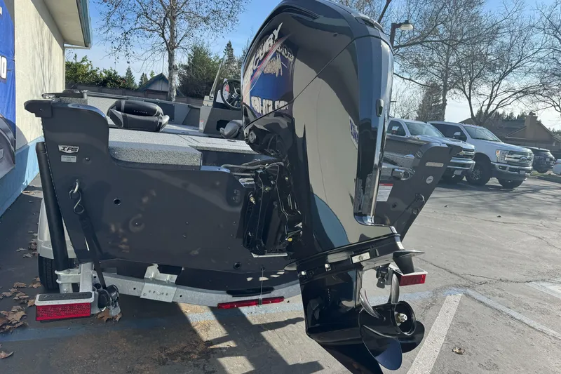 Slide: The Image of 2026 Lund 1675 Adventure SS boat with powerful outboard motor in parking lot. - 5