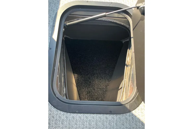 Slide: The Image of Open storage compartment in 2026 Evotti 725CS vehicle, featuring a carpeted interior. - 4