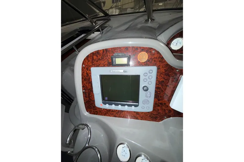 Slide: The Image of 2009 Regal Commodore 3760 IO boat dashboard with navigation equipment and steering wheel. - 13