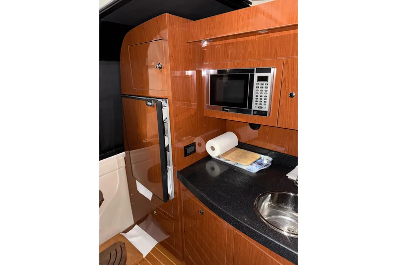 Slide: The Image of 2009 Regal Commodore 3760 IO interior with TV, seating, and wood accents. - 18