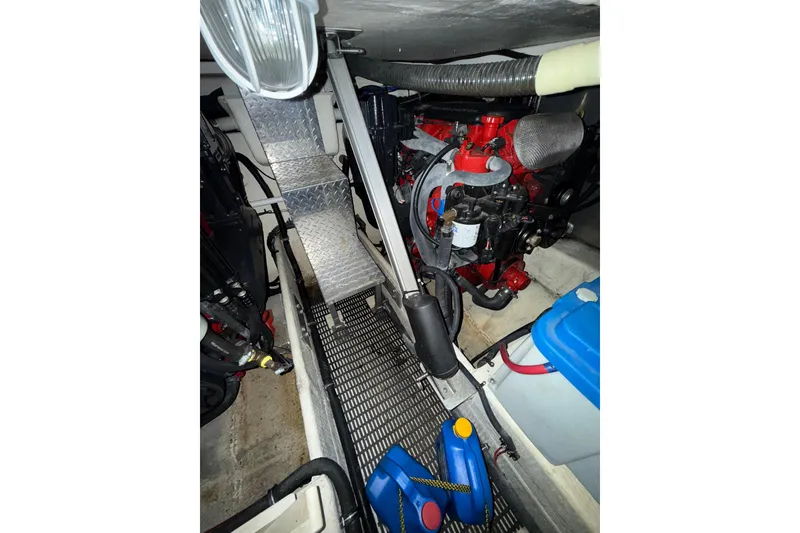 Slide: The Image of Engine compartment of 2009 Regal Commodore 3760 IO boat, featuring mechanical components and metal steps. - 25