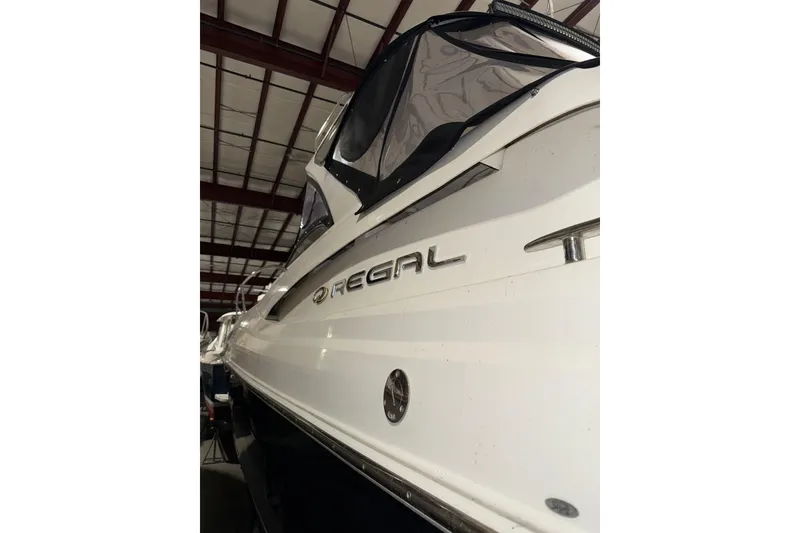 Slide: The Image of 2009 Regal Commodore 3760 IO boat in storage, showcasing sleek design and branding. - 4