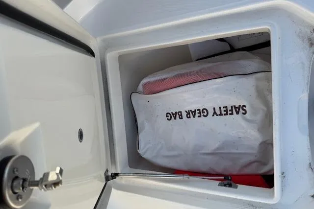 Slide: The Image of 2023 Regulator 31 boat storage compartment with safety gear bag inside. - 13