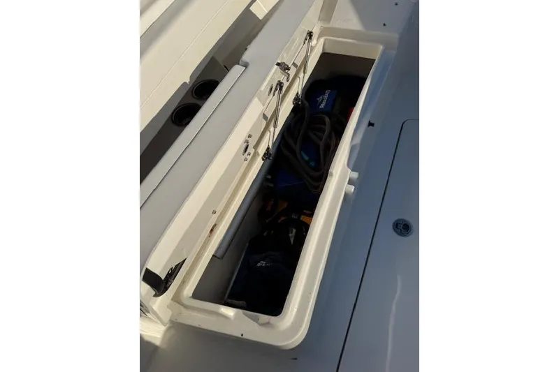Slide: The Image of 2023 Regulator 31 boat storage compartment with gear and accessories. - 14
