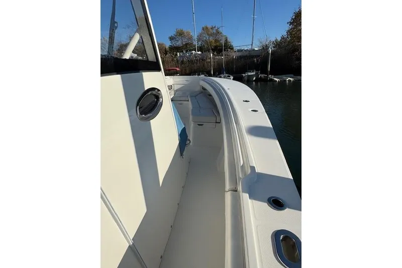 Slide: The Image of 2023 Regulator 31 boat deck with seating, docked in a marina. - 15