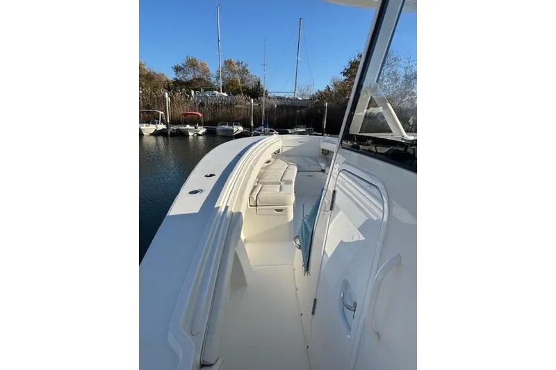 Slide: The Image of 2023 Regulator 31 boat docked, showcasing sleek design and spacious deck. - 16