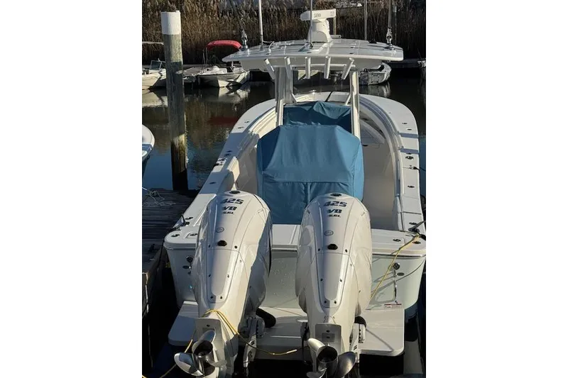 Slide: The Image of 2023 Regulator 31 boat with twin Yamaha engines docked at marina. - 2