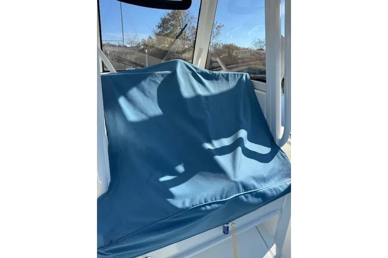 Slide: The Image of Blue seat cover on 2023 Regulator 31 boat, sunlight casting shadows. - 23