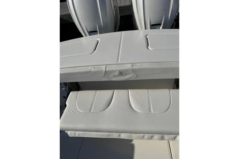 Slide: The Image of 2023 Regulator 31 boat with white seating and dual engines. - 24