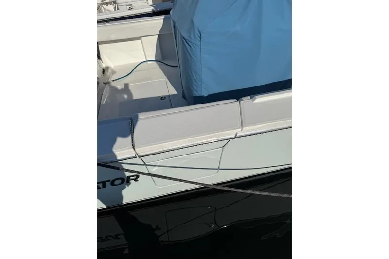 Slide: The Image of 2023 Regulator 31 boat with blue cover and white seating. - 25