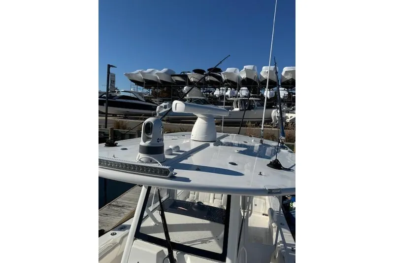 Slide: The Image of 2023 Regulator 31 boat with advanced radar and navigation equipment on deck. - 30