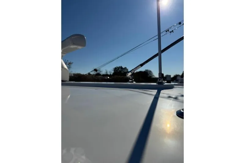 Slide: The Image of 2023 Regulator 31 boat deck with clear blue sky and sunlight. - 32