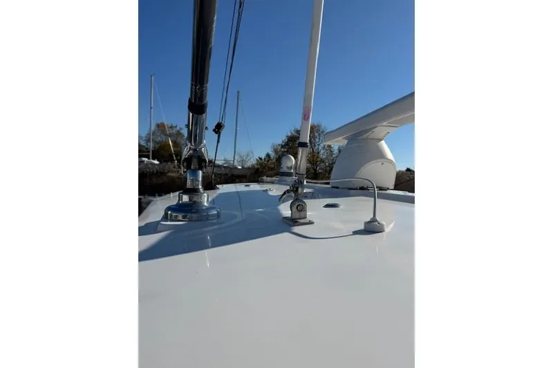 Slide: The Image of 2023 Regulator 31 boat deck with antennas and equipment under clear blue sky. - 33