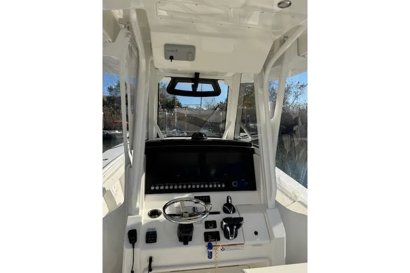 Slide: The Image of 2023 Regulator 31 boat cockpit with steering wheel and control panel. - 34