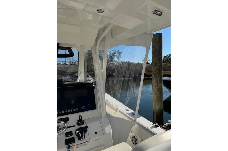 Slide: The Image of 2023 Regulator 31 boat interior with control panel and clear enclosure. - 37