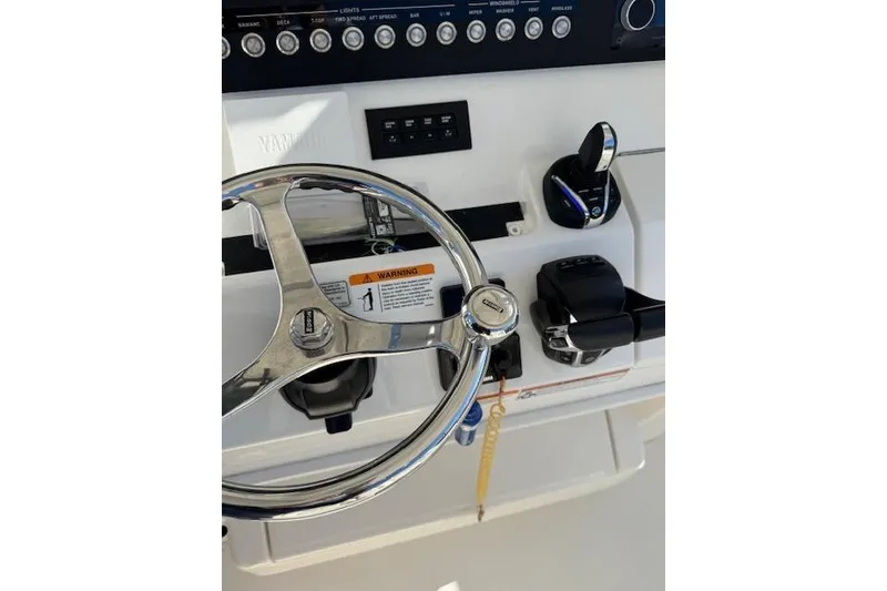 Slide: The Image of 2023 Regulator 31 boat helm with steering wheel and controls. - 38