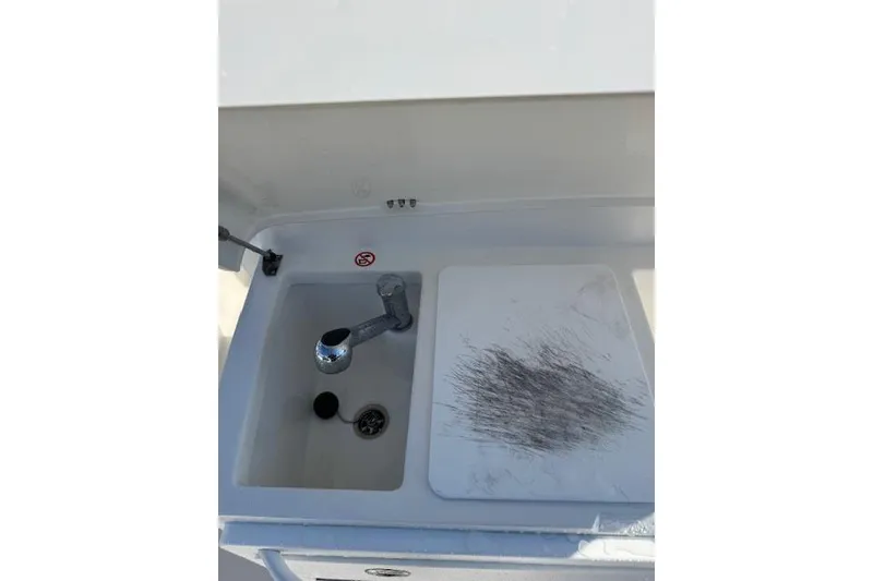 Slide: The Image of 2023 Regulator 31 boat sink and cutting board setup. - 40