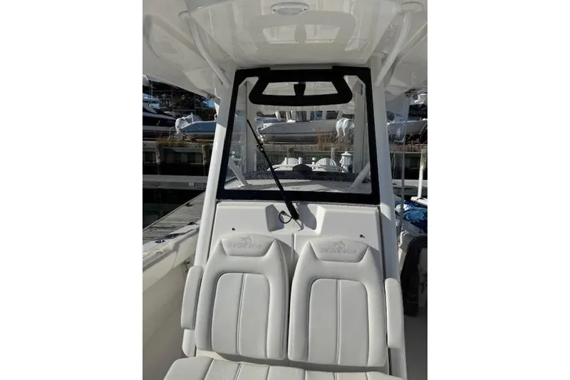Slide: The Image of 2023 Regulator 31 boat interior with white seating and windshield view. - 41