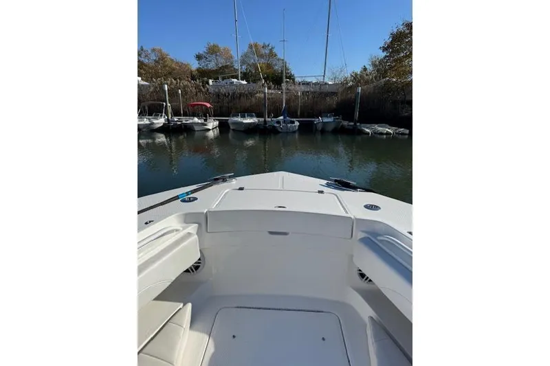 Slide: The Image of 2023 Regulator 31 boat docked, view from bow, surrounded by other boats. - 42