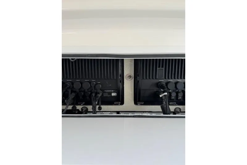 Slide: The Image of 2023 Regulator 31 boat electronics panel with wiring and controls. - 47