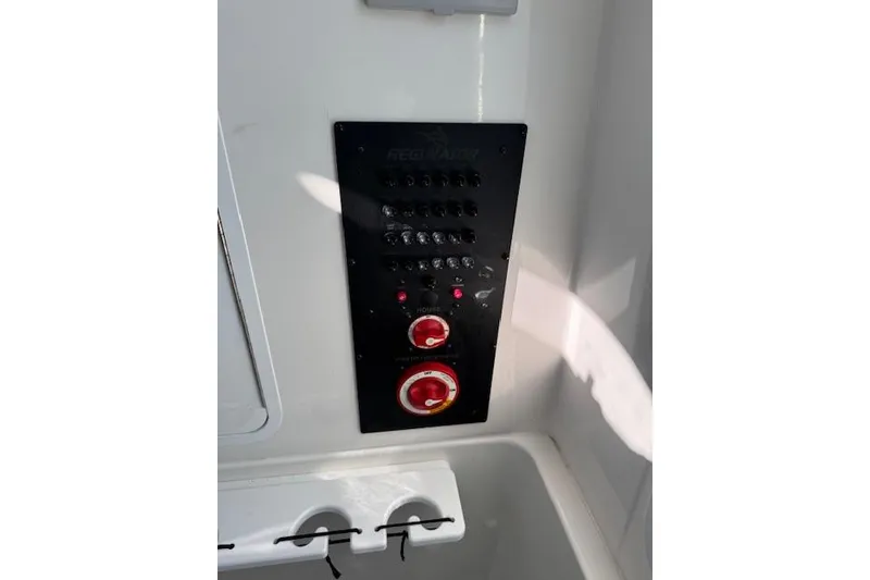 Slide: The Image of Control panel of 2023 Regulator 31 boat with switches and dials. - 48