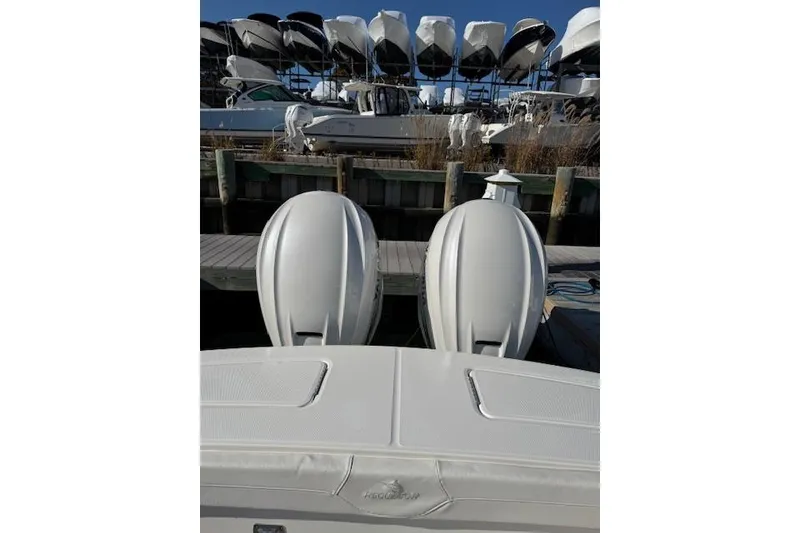 Slide: The Image of 2023 Regulator 31 boat with dual outboard engines docked at marina. - 50