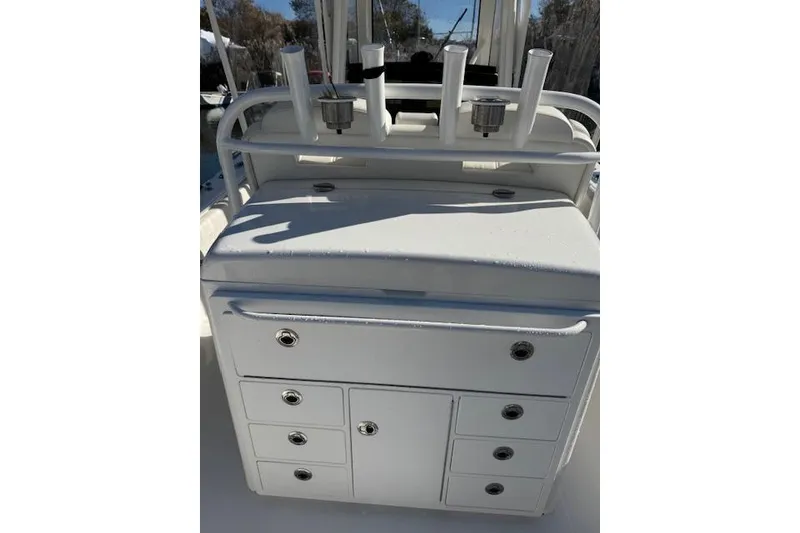 Slide: The Image of 2023 Regulator 31 boat console with storage drawers and rod holders. - 54