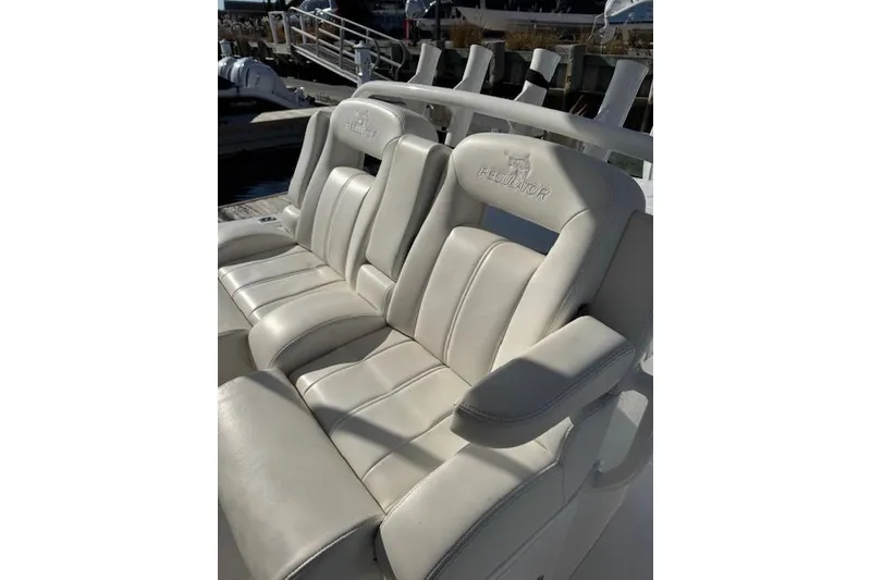 Slide: The Image of 2023 Regulator 31 boat seats, white leather, docked in marina. - 57