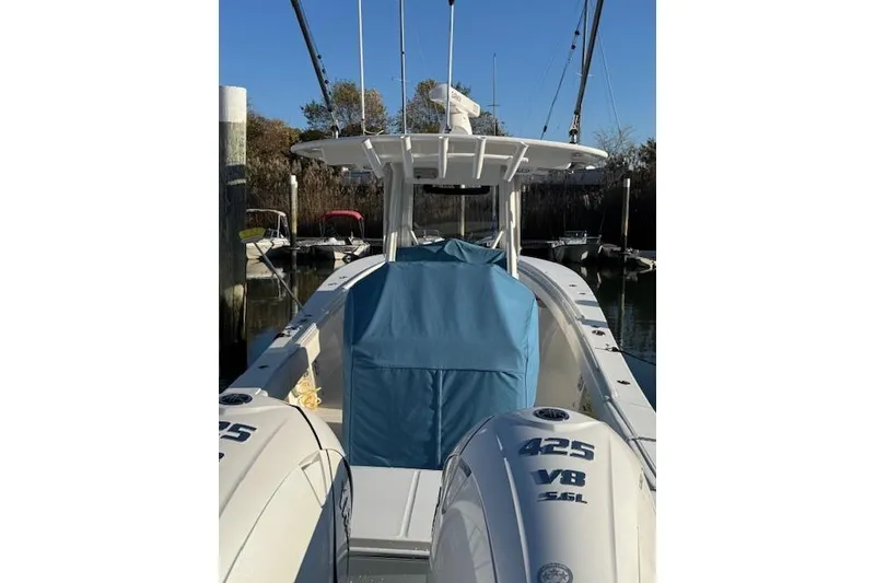 Slide: The Image of 2023 Regulator 31 boat with twin 425 V8 engines, docked in a marina. - 6