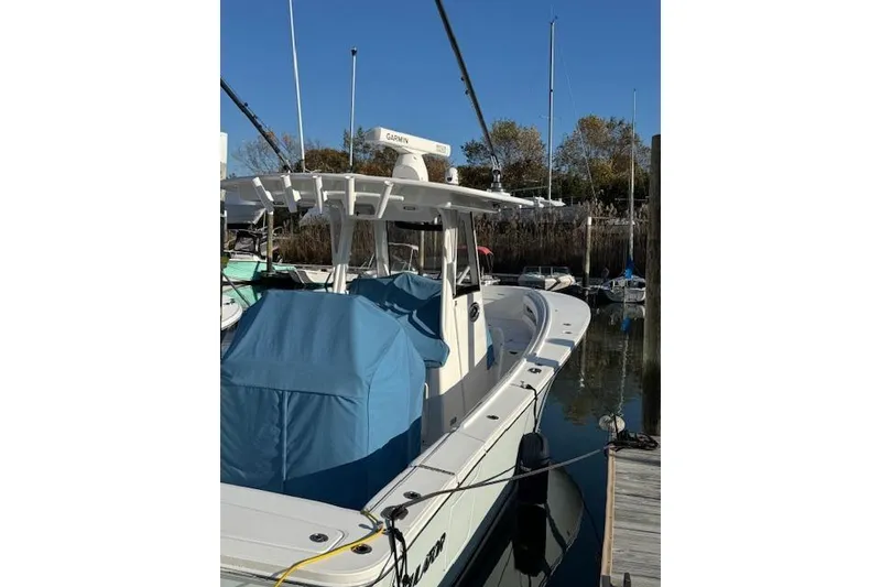 Slide: The Image of 2023 Regulator 31 boat docked, featuring a covered console and Garmin equipment. - 7