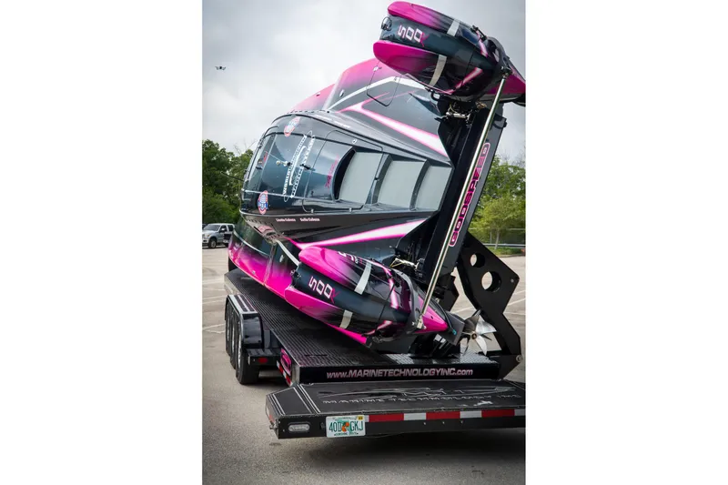 Slide: The Image of 2023 MTI 390XR powerboat in vibrant pink and black on a trailer. - 20