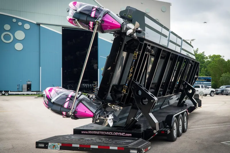 Slide: The Image of 2023 MTI 390XR powerboat on a trailer, featuring vibrant pink accents. - 21