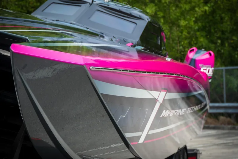 Slide: The Image of 2023 MTI 390XR powerboat with vibrant pink accents and sleek design. - 29
