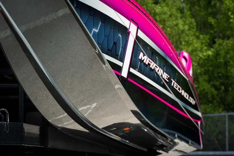 Slide: The Image of 2023 MTI 390XR boat with vibrant pink and black design, showcasing "Marine Technology" branding. - 31