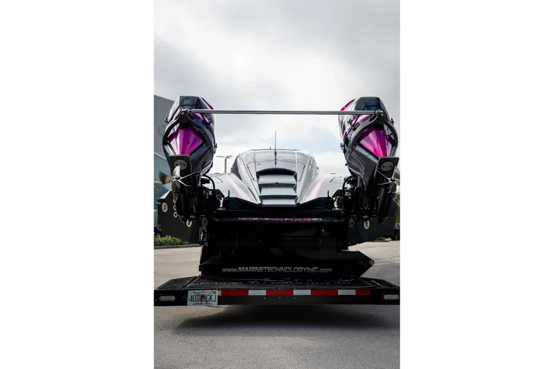 Slide: The Image of 2023 MTI 390XR powerboat with dual engines on a trailer, rear view. - 35