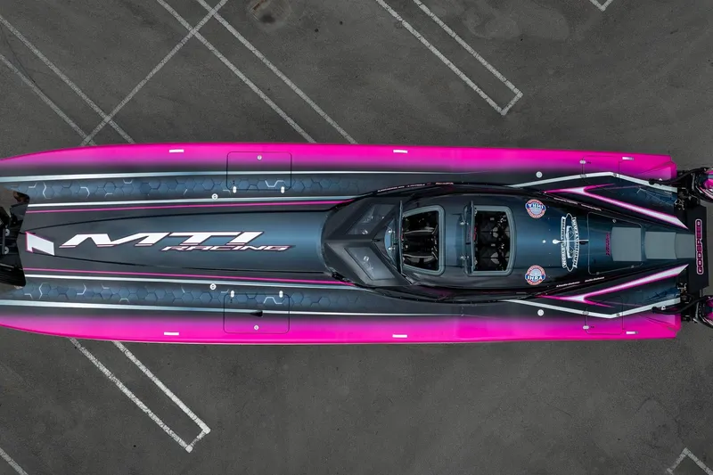 Slide: The Image of Aerial view of 2023 MTI 390XR racing boat with vibrant pink accents. - 45