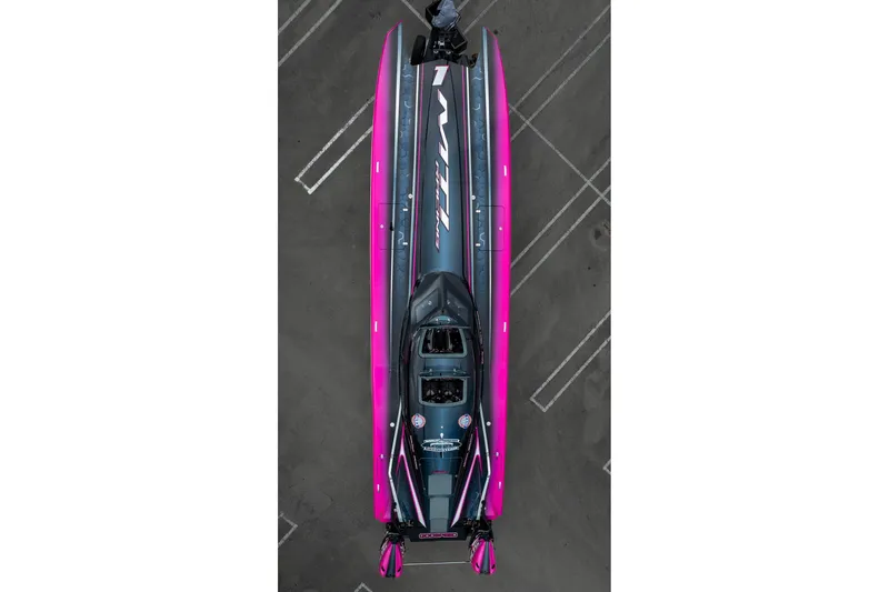 Slide: The Image of Aerial view of 2023 MTI 390XR powerboat with vibrant pink and gray design. - 46