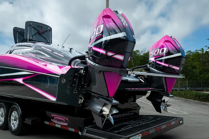 Slide: The Image of 2023 MTI 390XR boat with vibrant pink and black design, featuring dual 500 competition engines. - 49