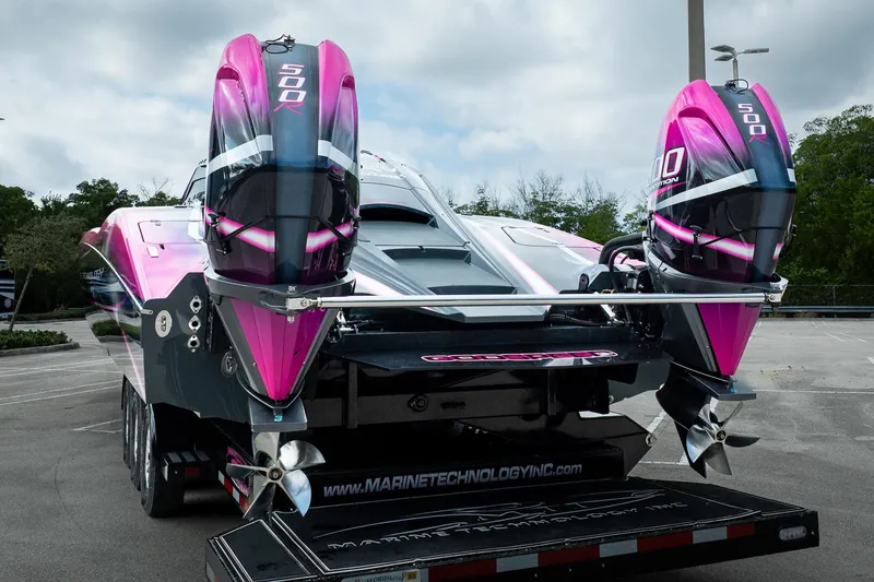 Slide: The Image of 2023 MTI 390XR powerboat with dual 500R engines, vibrant pink and black design. - 51