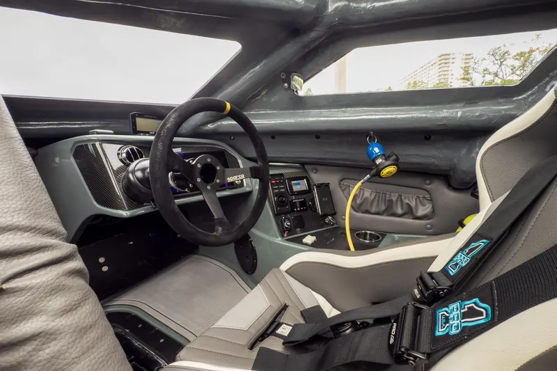 Slide: The Image of Interior of 2023 MTI 390XR race car with Sparco steering wheel and safety harness. - 62