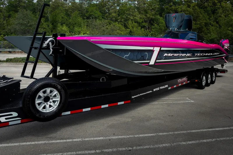 Slide: The Image of 2023 MTI 390XR powerboat on trailer, vibrant pink and black design. - 70