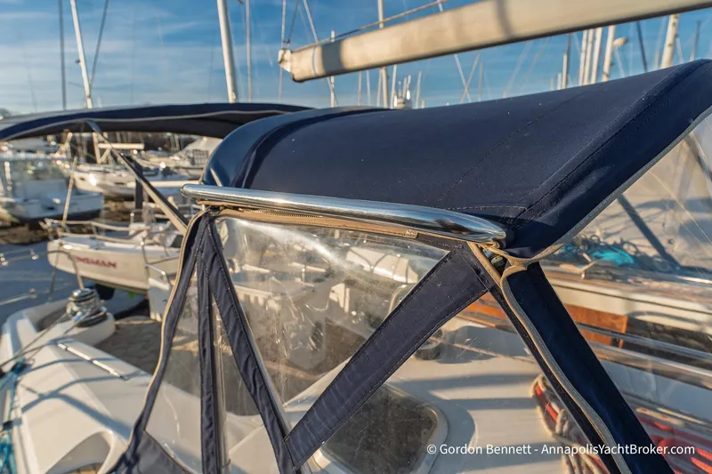 Slide: The Image of 2004 Jeanneau Sun Odyssey 43 DS sailboat with blue canvas cover in marina setting. - 17