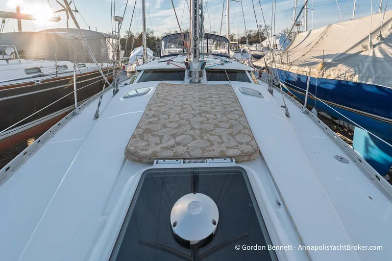 Slide: The Image of 2004 Jeanneau Sun Odyssey 43 DS sailboat deck with sun pad, docked in marina. - 26