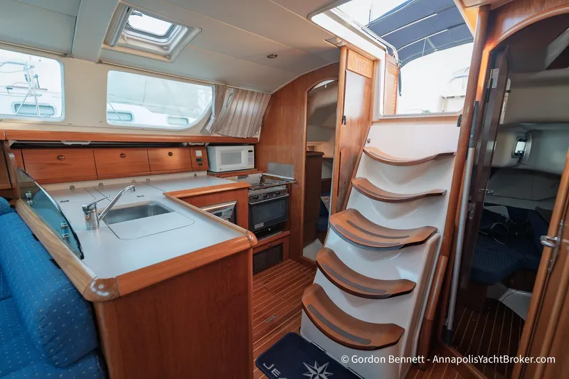 Slide: The Image of Interior of 2004 Jeanneau Sun Odyssey 43 DS yacht, featuring kitchen and wooden stairs. - 33